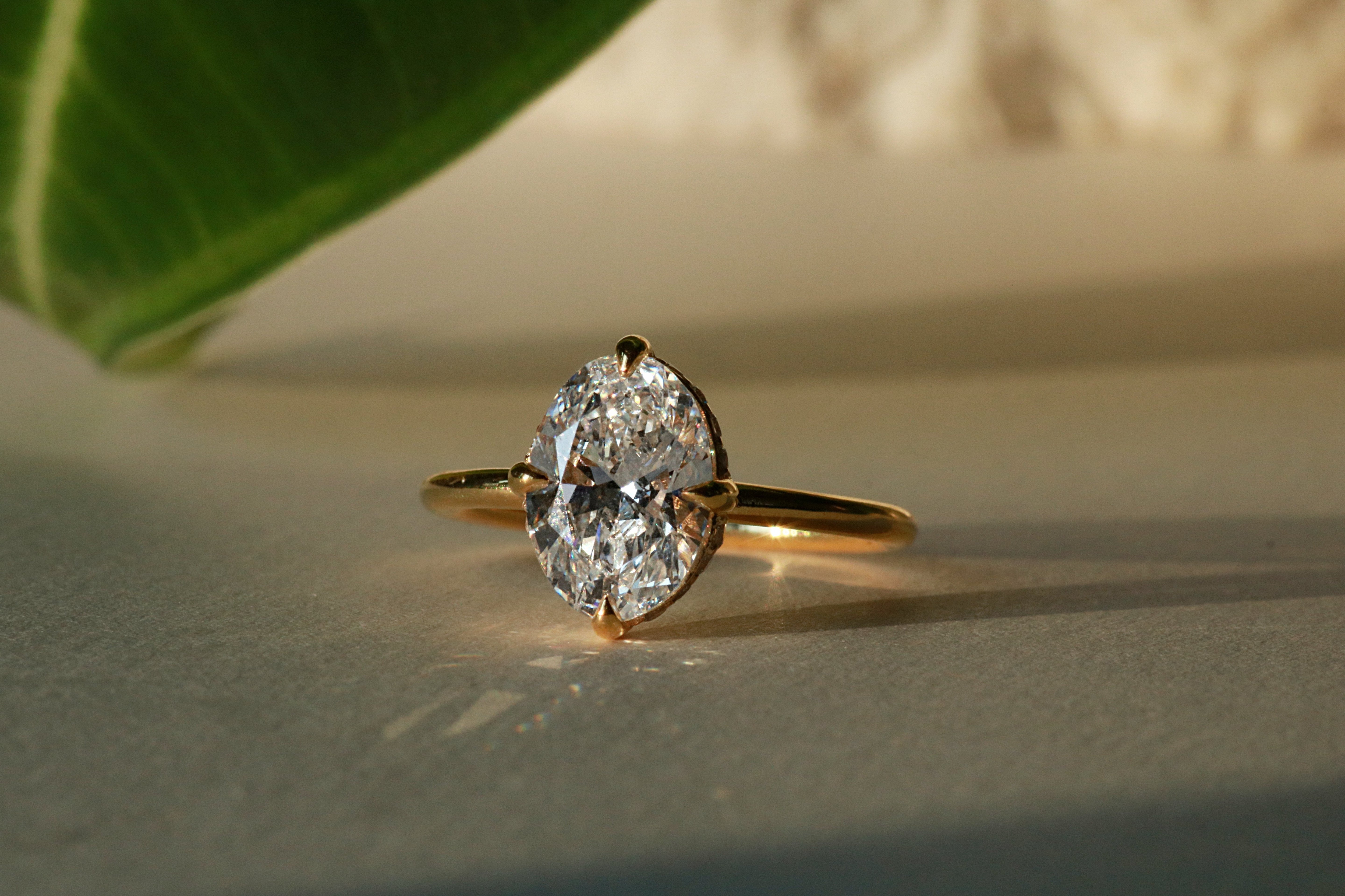Yellow Gold Oval diamond engagement ring with compass prongs