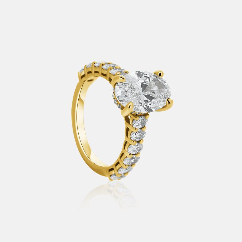 Oval engagement ring with ovals in the band and a hidden halo