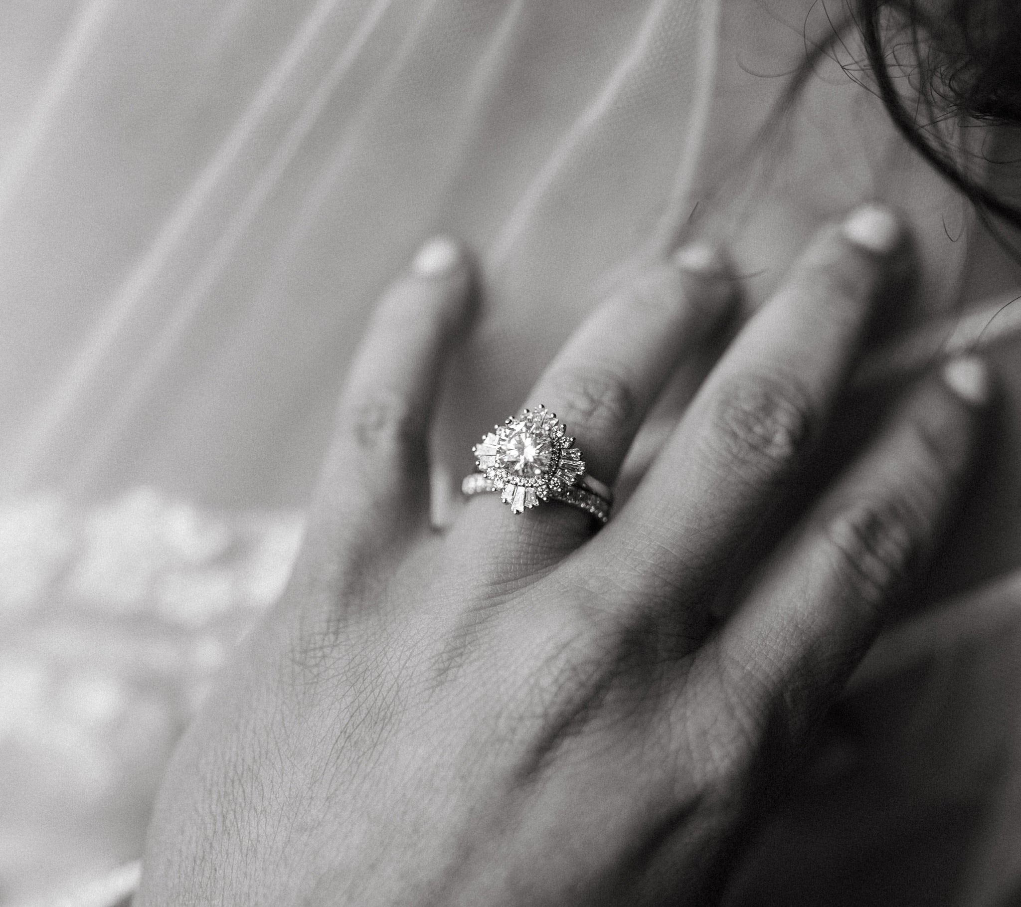 Ballerina diamond engagement ring on bride's hand.