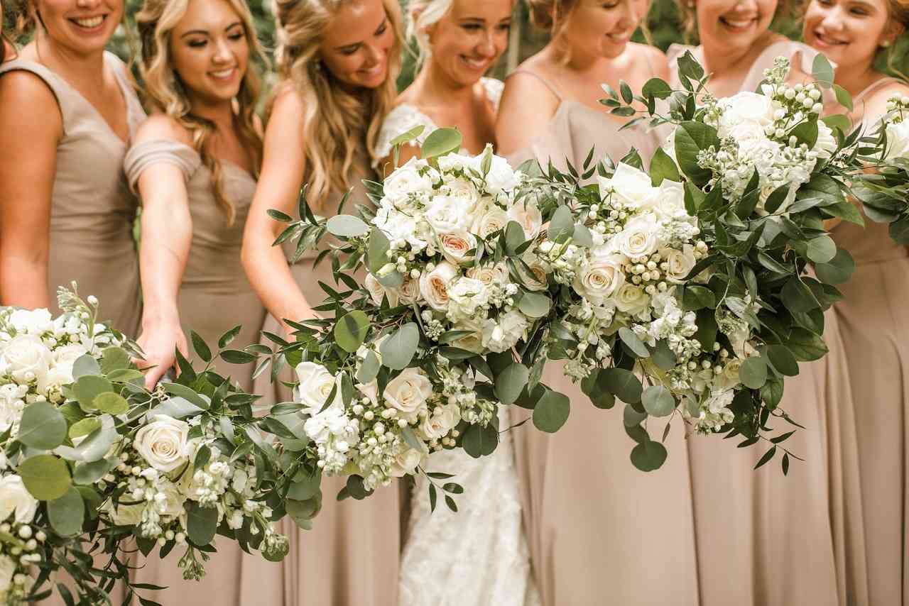 Bridesmaids holding flower bouquets for Holland Daze article.