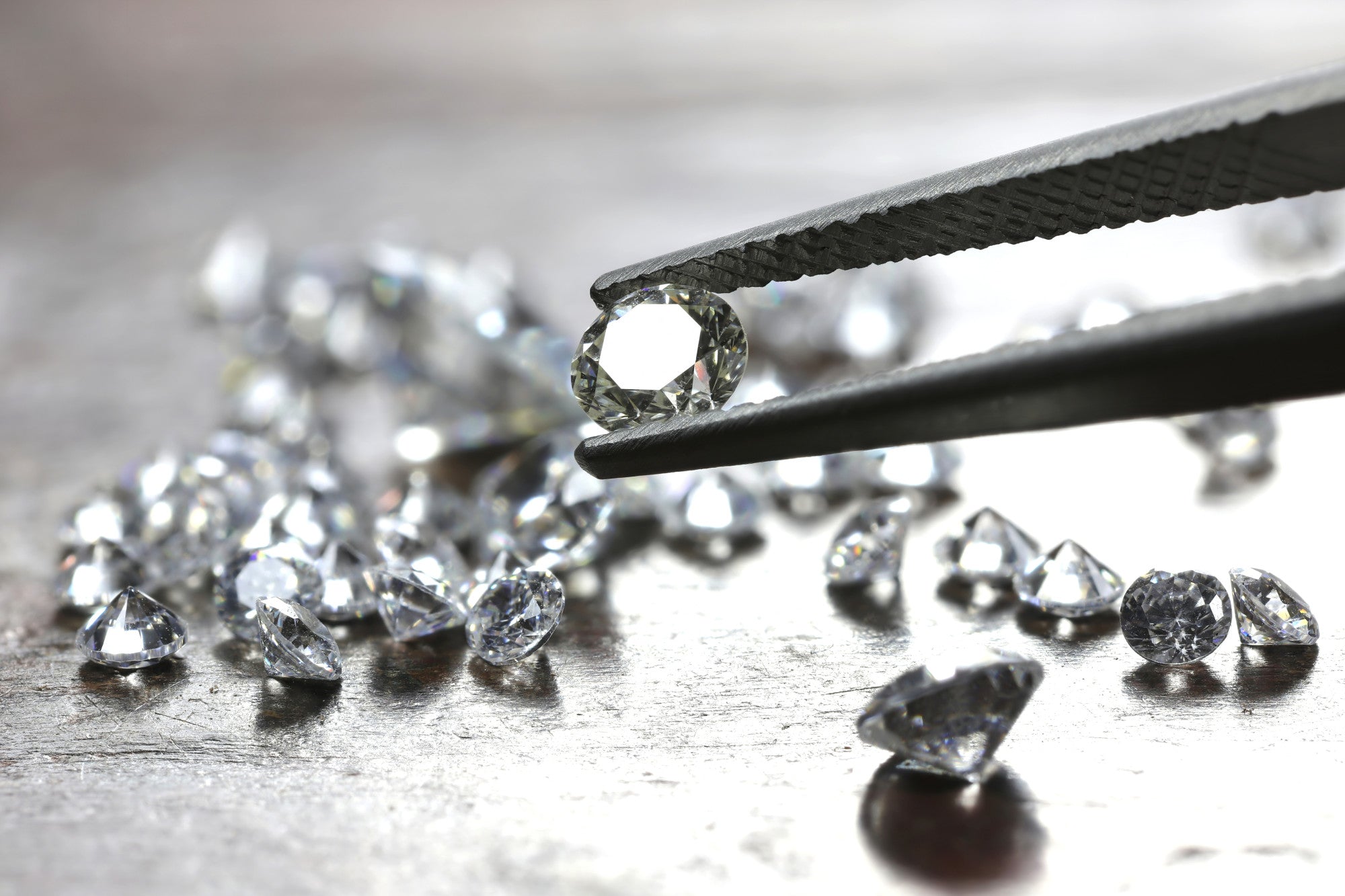 Diamond held in tweezers for sparkle inspection
