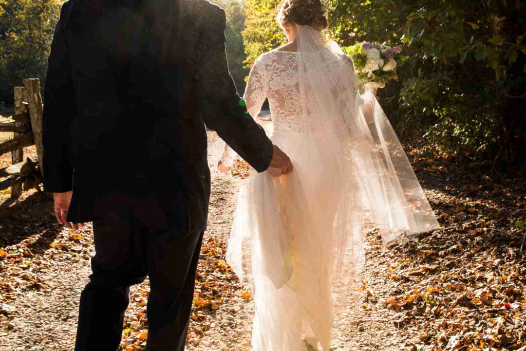 Bride and groom on a nature walk, symbolizing enduring love.