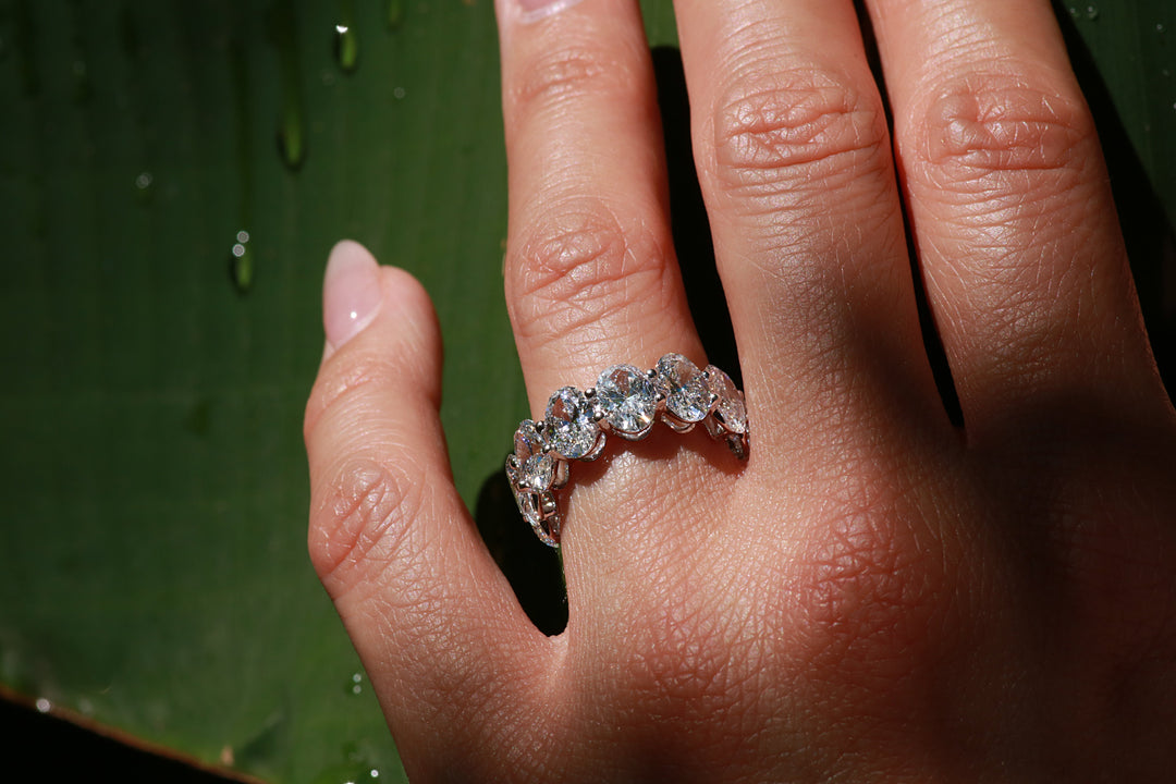 Large Oval Diamond eternity band in white gold worn on finger