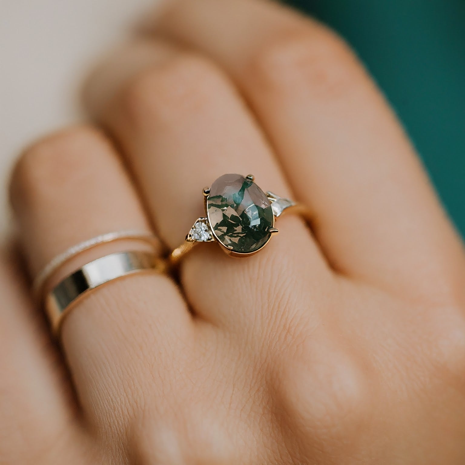 Oval moss agate and diamond engagement ring.