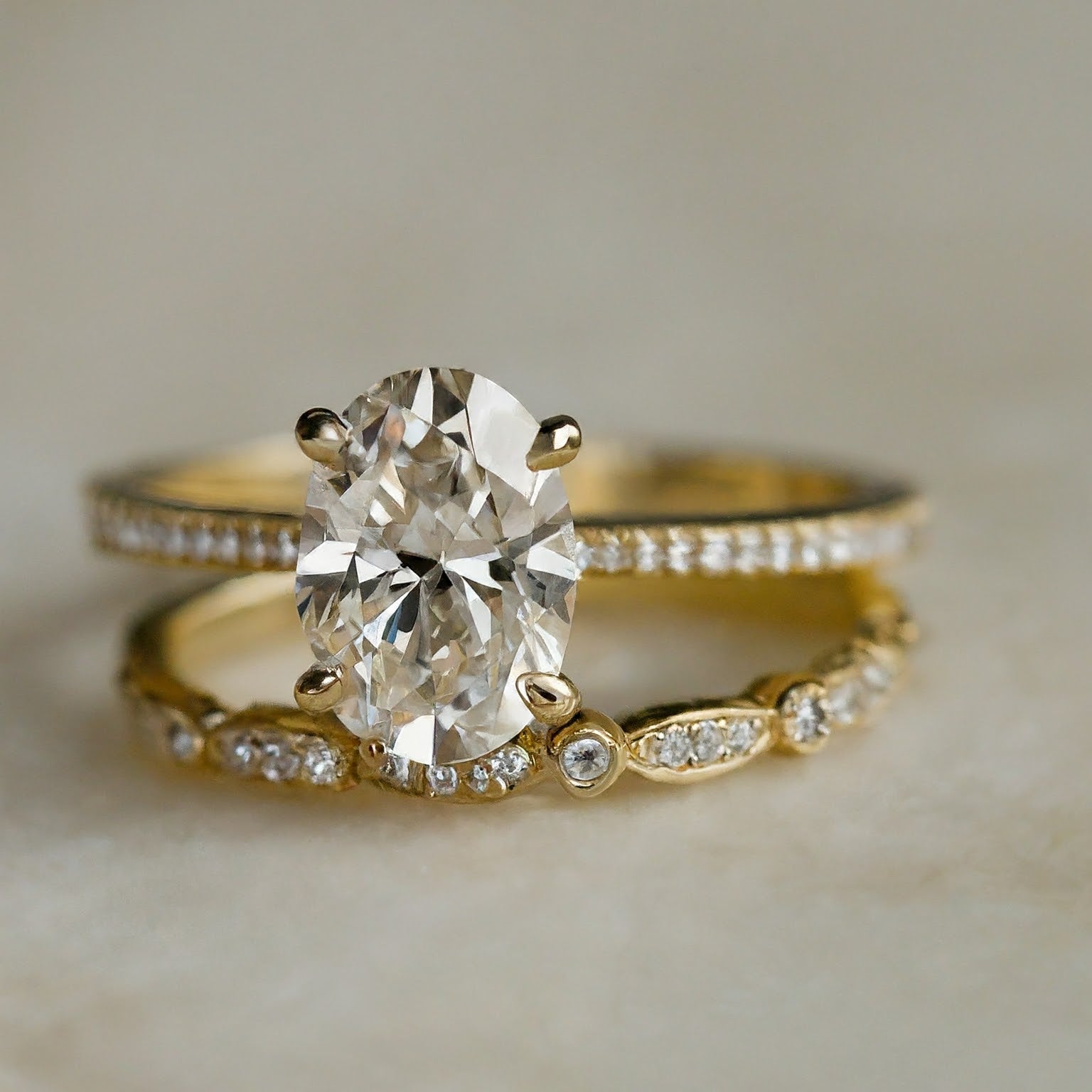 Minimalist oval diamond engagement ring in yellow gold.