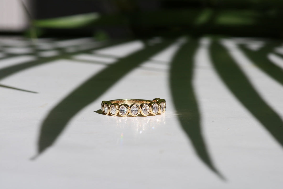 Diamond and gold bezel set wedding ring.