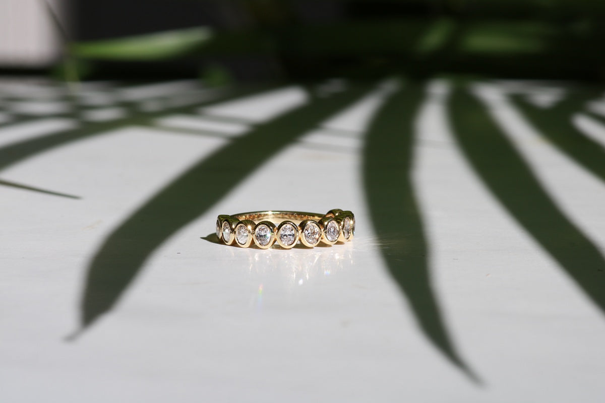 Diamond and gold bezel set wedding ring.