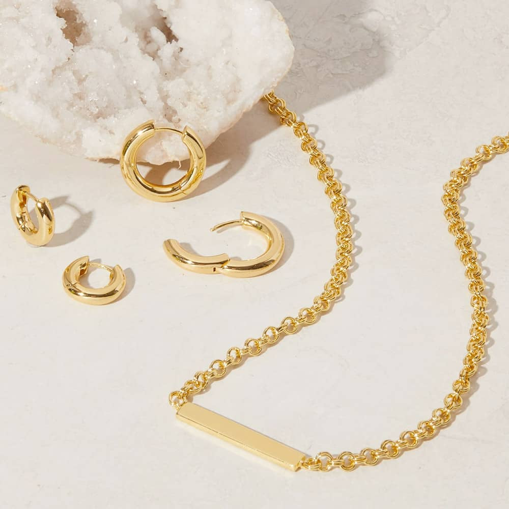 Gold hoop earrings and bar chain necklace.