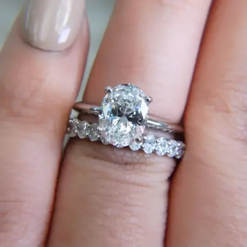 Oval diamond engagement ring and wedding band.
