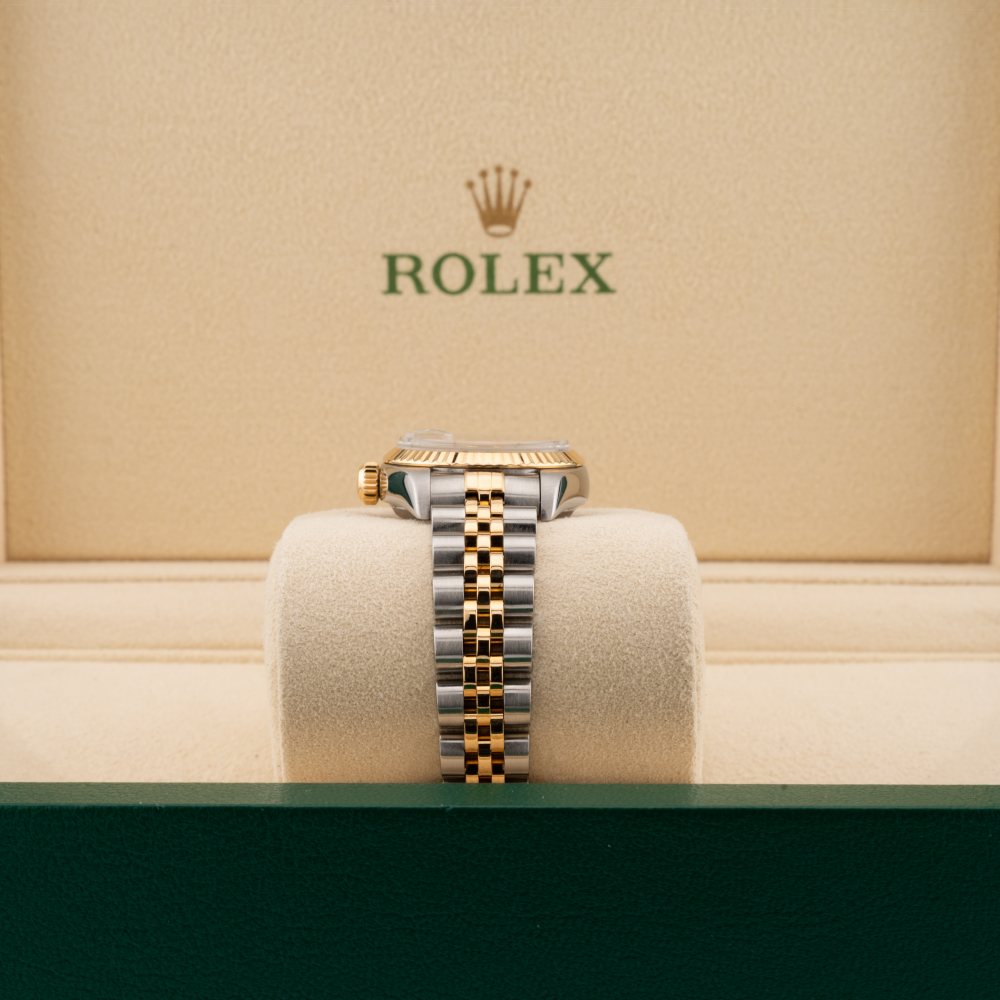 Rolex watch on a cushion with a beige background featuring the Rolex logo.