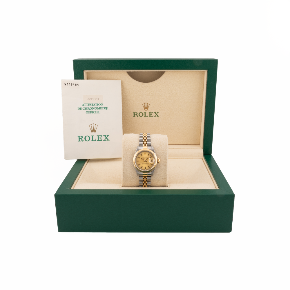 Rolex watch 69173 two tone in an open green box with a white background