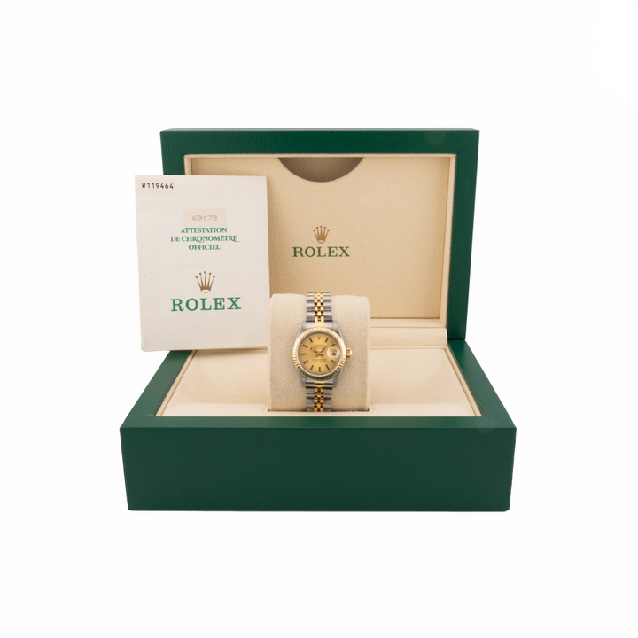 Rolex watch 69173 two tone in an open green box with a white background