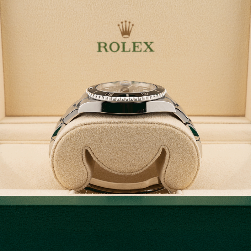 Rolex watch in a display case with the Rolex logo above