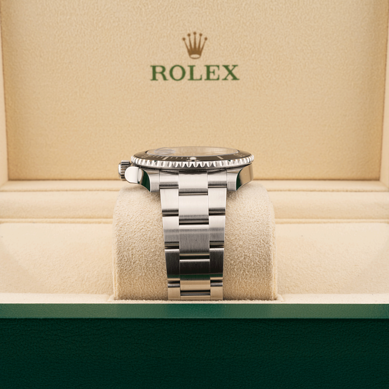 Rolex submariner watch on a cushion with a beige background