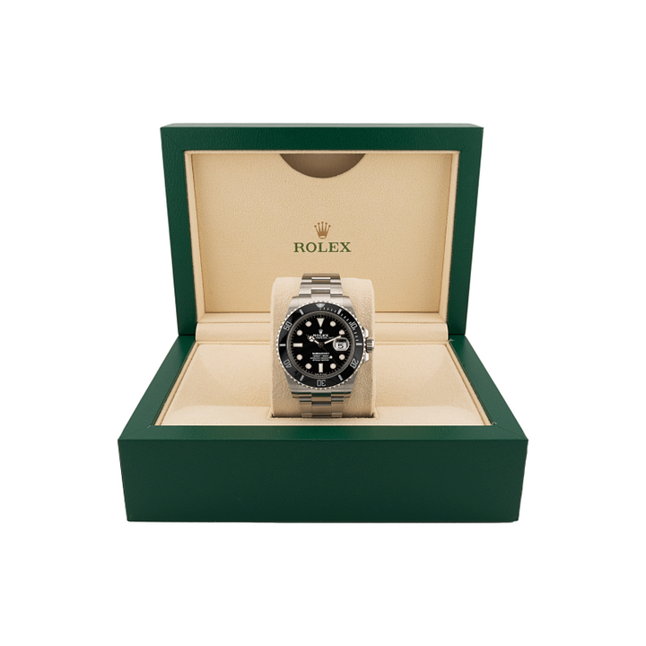 Rolex submariner watch in a green and beige box on a white background