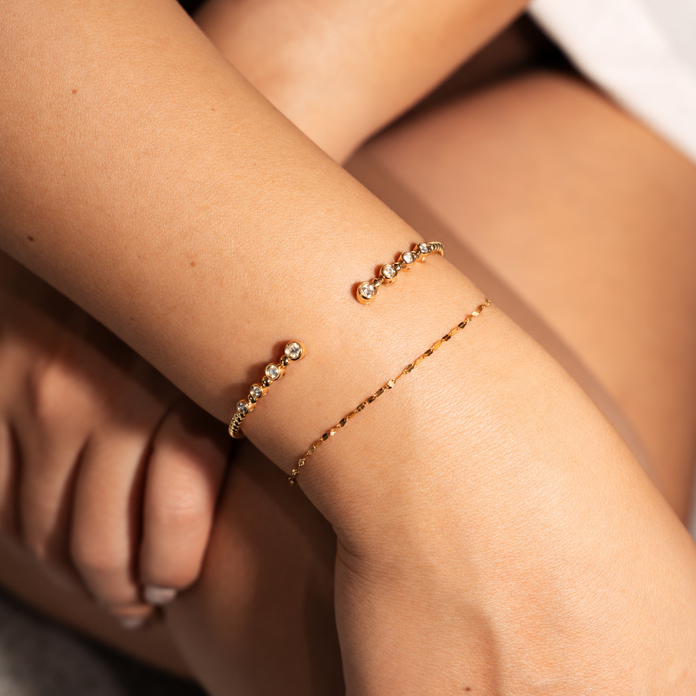 open cuff diamond bracelet that is bezel set with graduating diamonds on  wrist