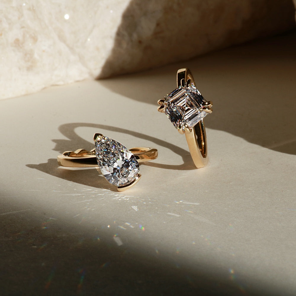 Masina Amie rings in gold with pear and radiant cut diamonds.