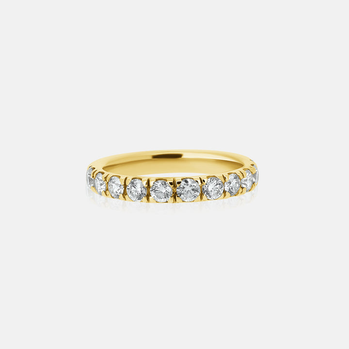 pave diamond wedding ring with round diamond in yellow gold 