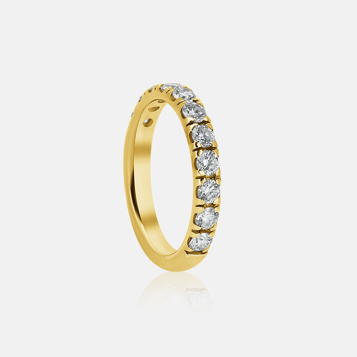 pave diamond wedding band with round diamond in yellow gold 