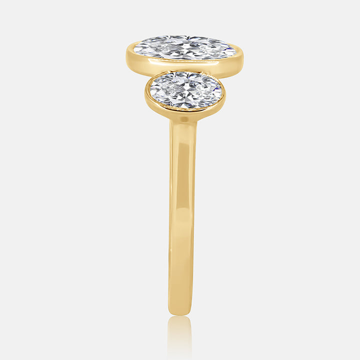 Three stone bezel oval diamond engagement ring in 14 karat yellow gold