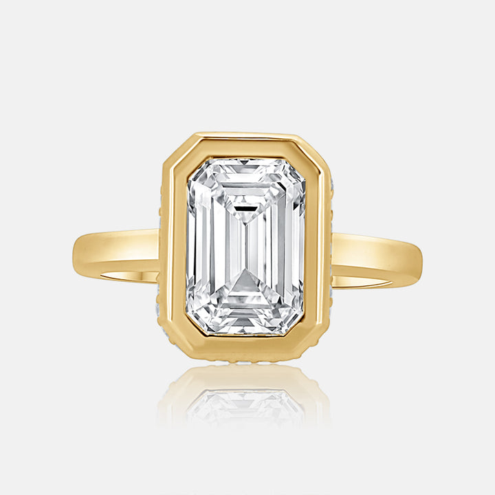 Emerald cut bezel set engagement ring with hidden halo