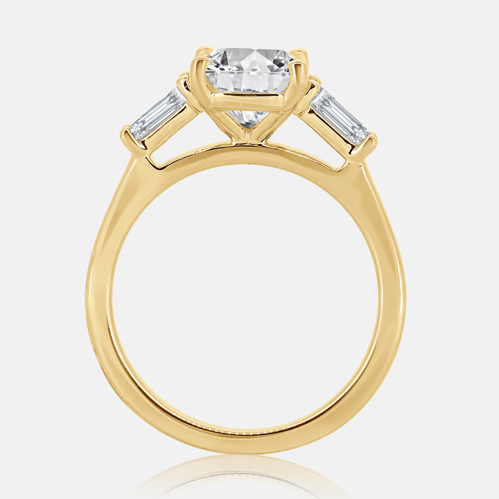 cushion cut three stone engagement ring with tapered baguette diamonds