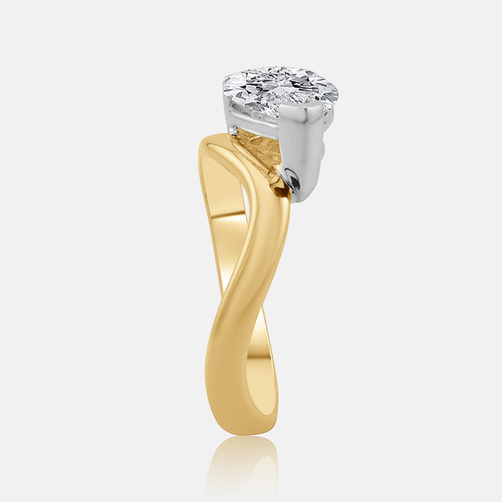east west pear shape diamond on a wave style gold ring