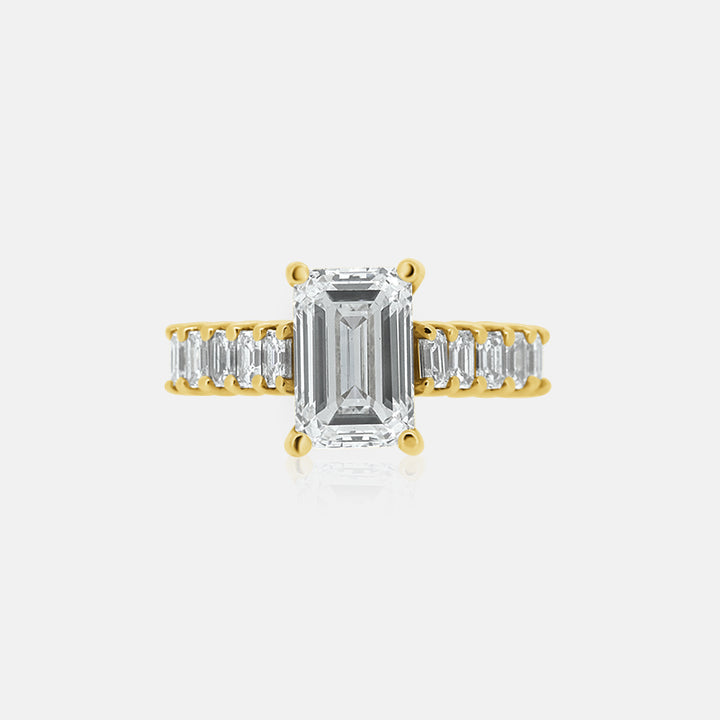 Emerald cut engagement ring with emerald cut side stones in yellow gold 