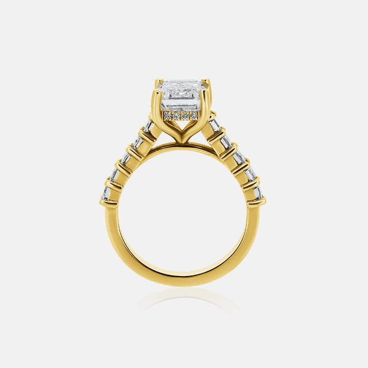 Emerald cut cathedral engagement ring with emerald cut side stones in yellow gold with a hidden halo