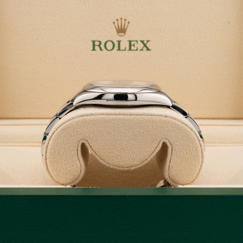 Rolex 124300 Green Dial Oyster perpetual  case displayed on its side in a Rolex beige box 