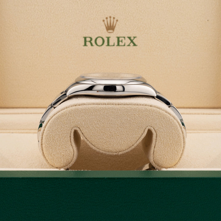 Rolex 124300 Green Dial Oyster perpetual  case displayed on its side in a Rolex beige box 
