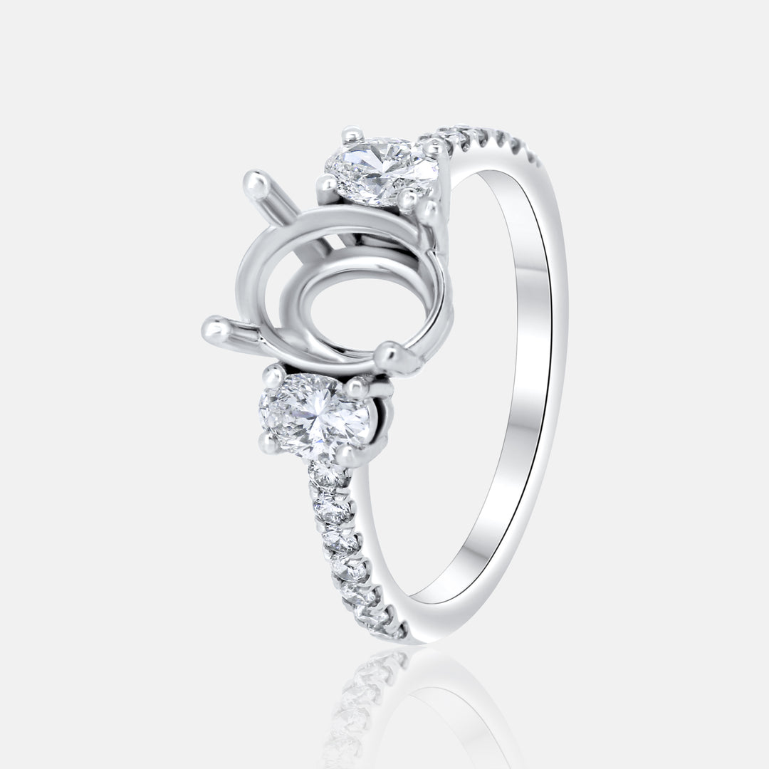 This stunning three-stone engagement ring promises a lifetime of brilliance. Two oval diamonds embrace an oval center stone (sold separately), all set in 14k white gold.