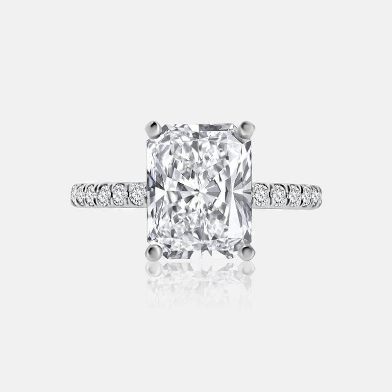 Diamond engagement ring in white gold with radiant-cut center stone.