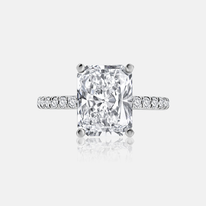Diamond engagement ring in white gold with radiant-cut center stone.