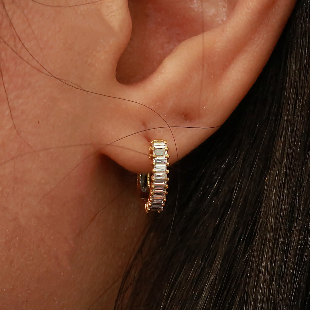 18K yellow gold baguette huggies set east to west with .31 carat of diamonds