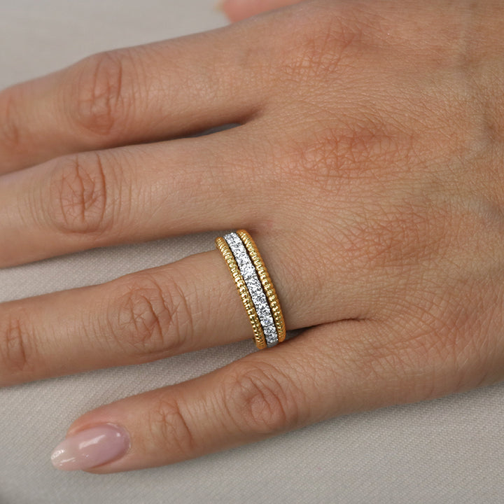 Yellow and white gold rope diamond wedding ring on hand