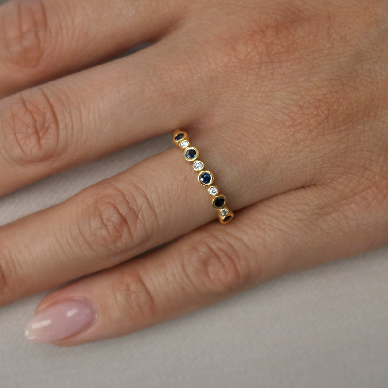 Yelloe gold sapphire and diamond wedding ring on hand