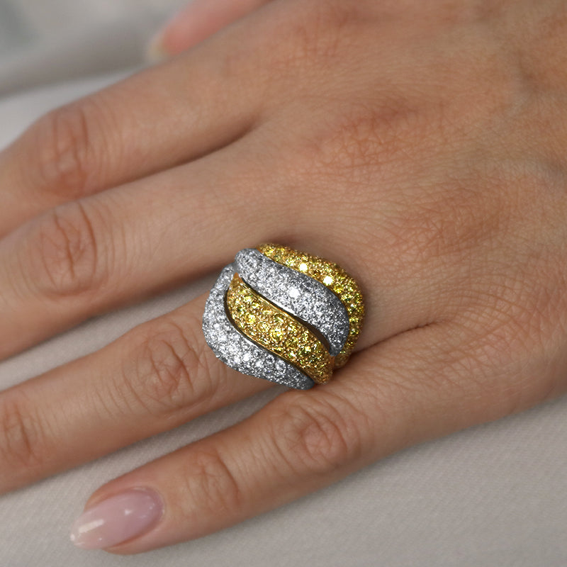 white and yellow diamond cocktail ring on hand